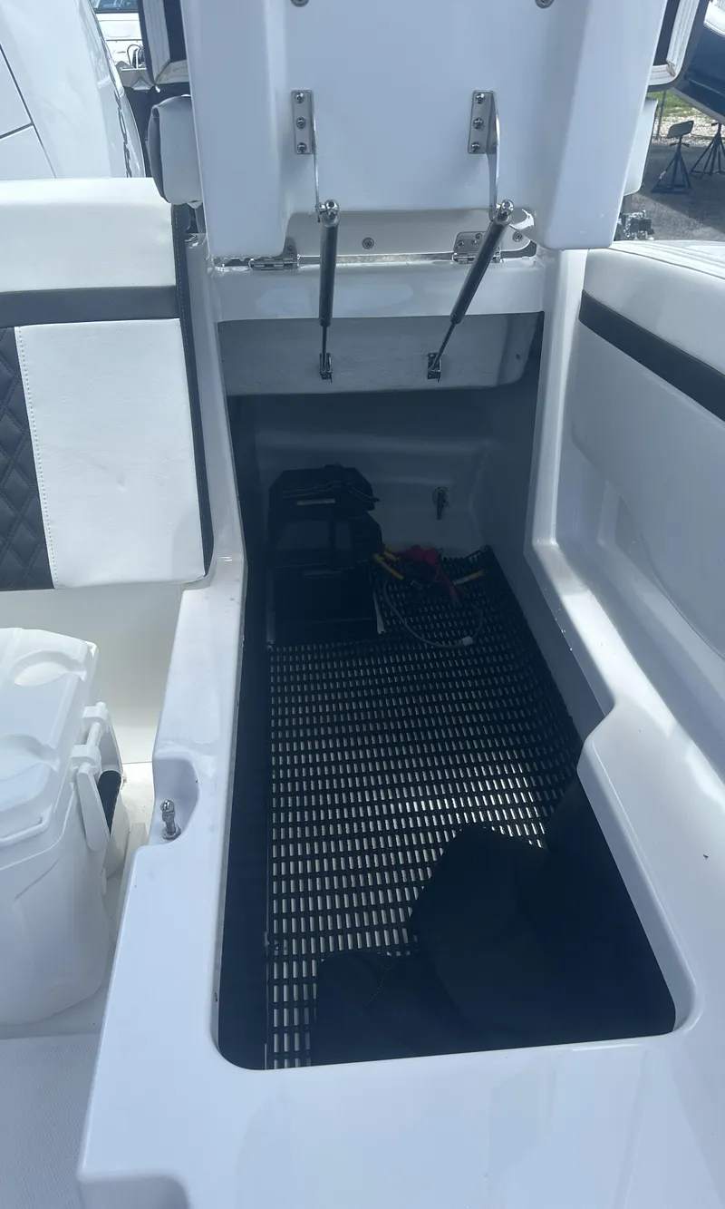 Slide: The Image of 2025 Monterey M-205 boat storage compartment with open hatch and visible interior. - 14