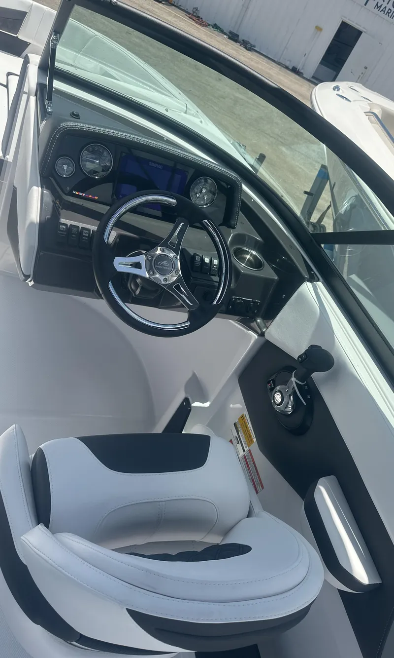 Slide: The Image of 2025 Monterey M-205 boat interior with modern dashboard and steering wheel. - 17