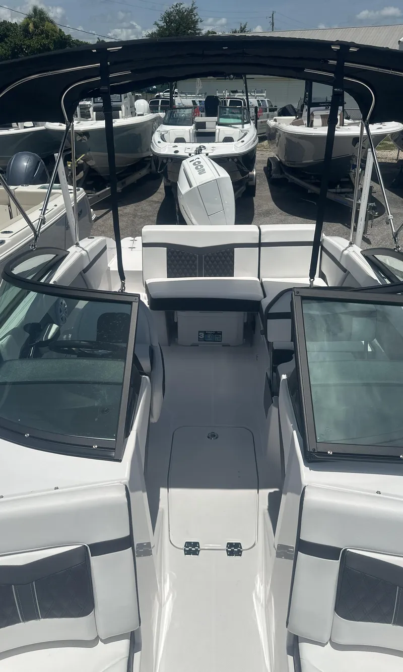 Slide: The Image of 2025 Monterey M-205 boat with sleek design, docked among other boats. - 21