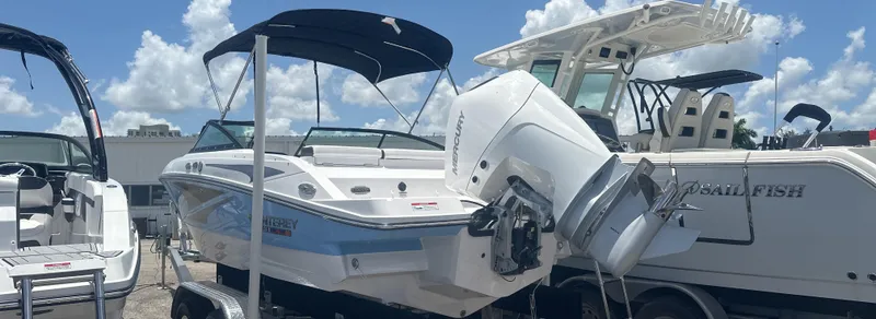 Slide: The Image of 2025 Monterey M-205 boat with outboard motor, parked under a sunny sky. - 4