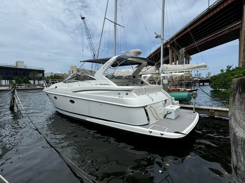 Slide: The Image of 2003 Regal Commodore 3860 yacht docked in marina under bridge. - 1