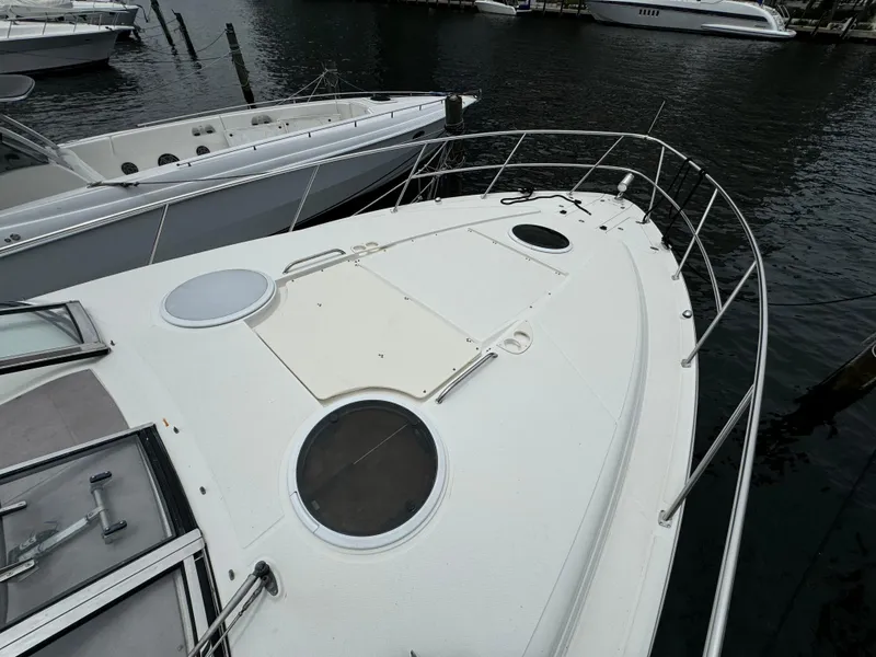 Slide: The Image of 2003 Regal Commodore 3860 yacht docked at marina, showcasing sleek deck design. - 15