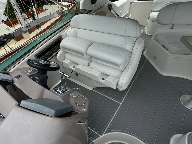 Slide: The Image of 2003 Regal Commodore 3860 yacht interior with white leather seating and modern helm controls. - 17