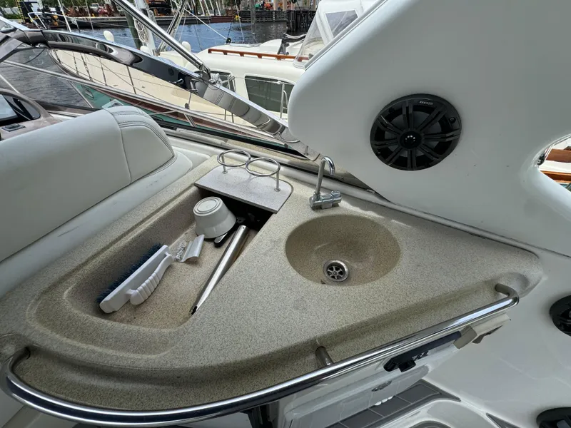 Slide: The Image of 2003 Regal Commodore 3860 yacht sink area with faucet and storage compartments. - 22