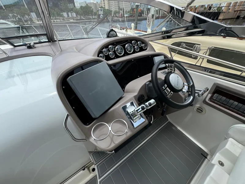 Slide: The Image of 2003 Regal Commodore 3860 yacht helm with steering wheel and control panel. - 23