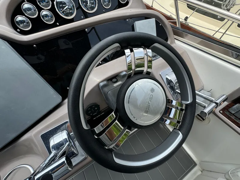 Slide: The Image of Steering wheel of 2003 Regal Commodore 3860 boat with dashboard instruments. - 24