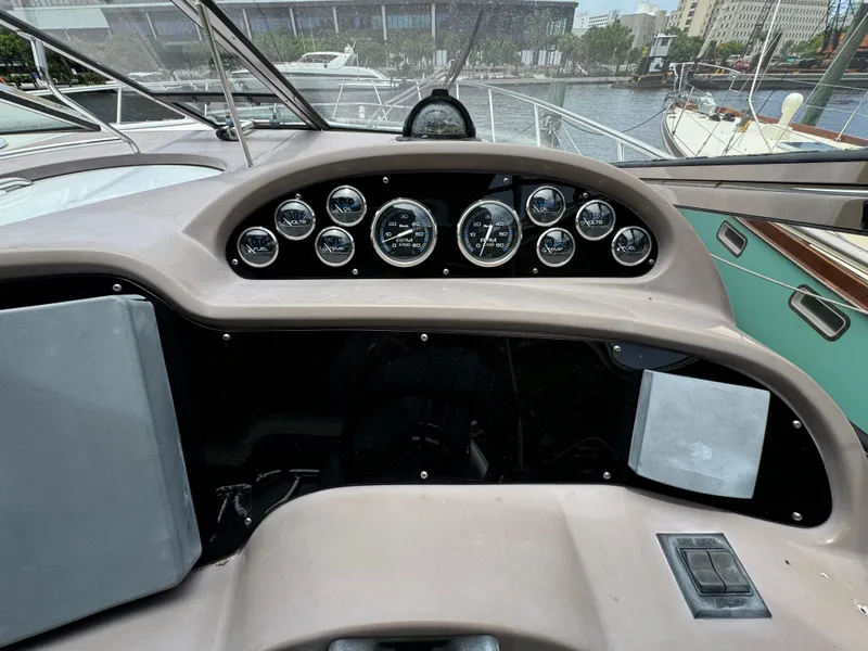Slide: The Image of 2003 Regal Commodore 3860 dashboard with gauges and controls, docked in a marina. - 26