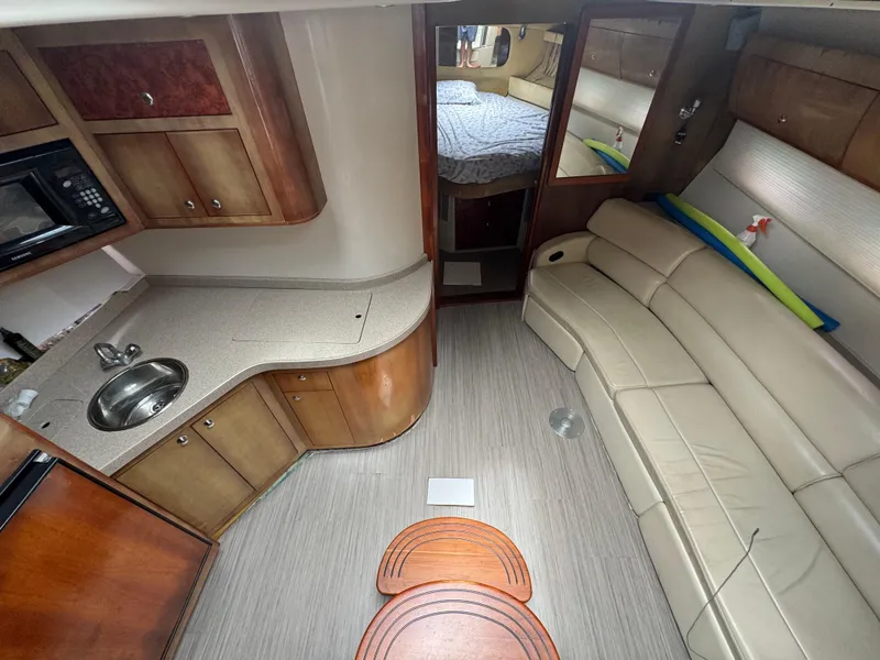 Slide: The Image of 2003 Regal Commodore 3860 yacht interior with kitchen, seating, and bedroom area. - 29