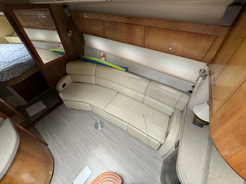 Slide: The Image of Interior of 2003 Regal Commodore 3860 yacht with beige leather seating and wooden cabinetry. - 30