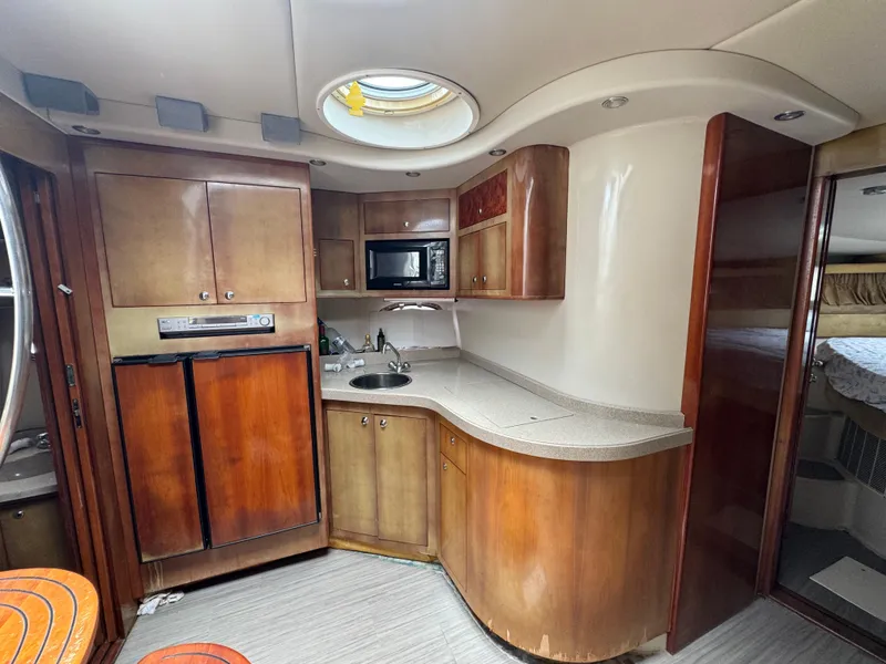 Slide: The Image of 2003 Regal Commodore 3860 yacht kitchen with wood cabinets and modern appliances. - 31