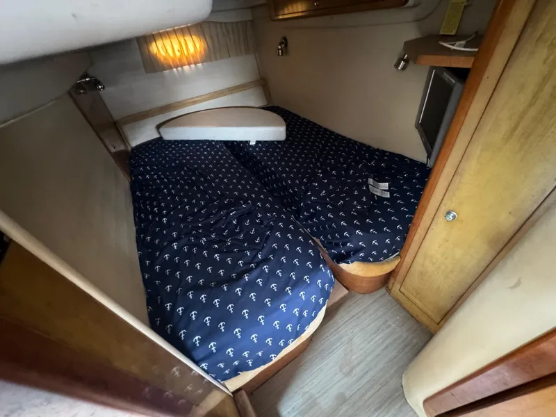 Slide: The Image of 2003 Regal Commodore 3860 cabin with twin beds and nautical-themed bedding. - 33