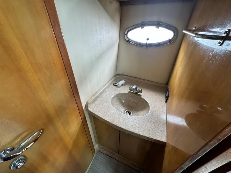 Slide: The Image of 2003 Regal Commodore 3860 bathroom with sink and porthole window. - 34