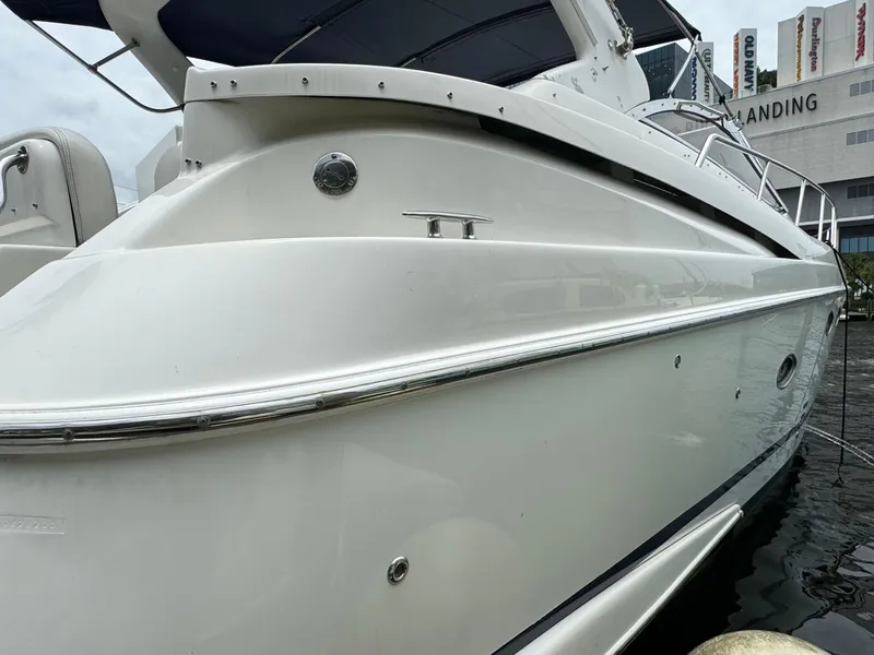 Slide: The Image of 2003 Regal Commodore 3860 yacht docked near a waterfront building. - 4