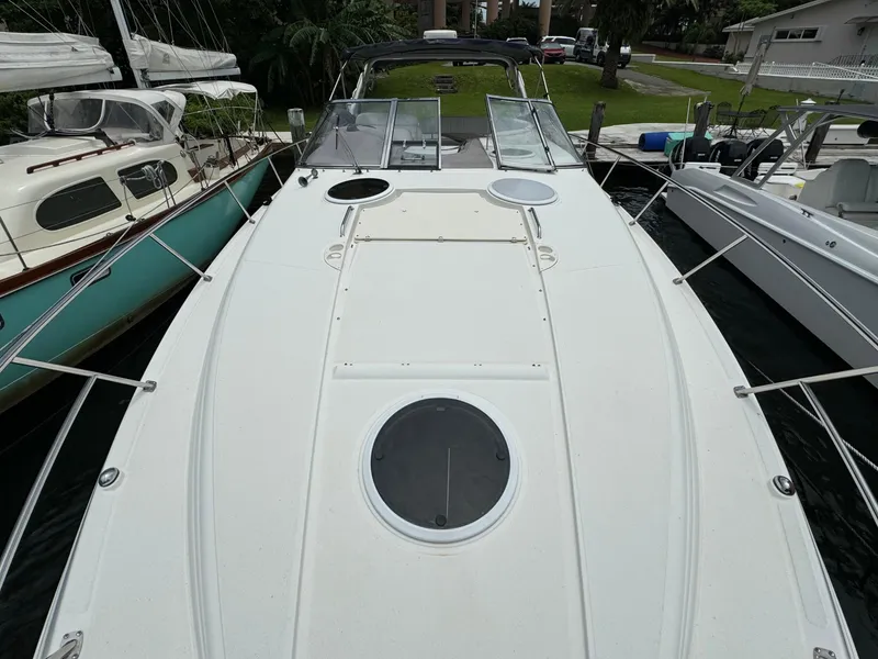 Slide: The Image of 2003 Regal Commodore 3860 yacht docked between two boats. - 44