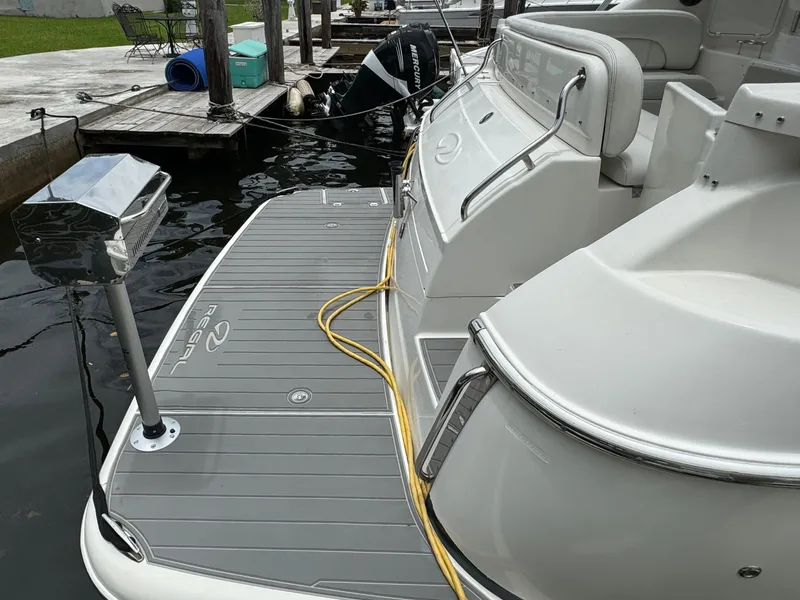 Slide: The Image of 2003 Regal Commodore 3860 yacht docked, featuring spacious deck and seating area. - 5