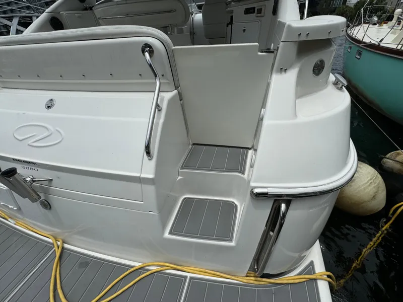 Slide: The Image of 2003 Regal Commodore 3860 yacht stern with steps and docked at marina. - 8