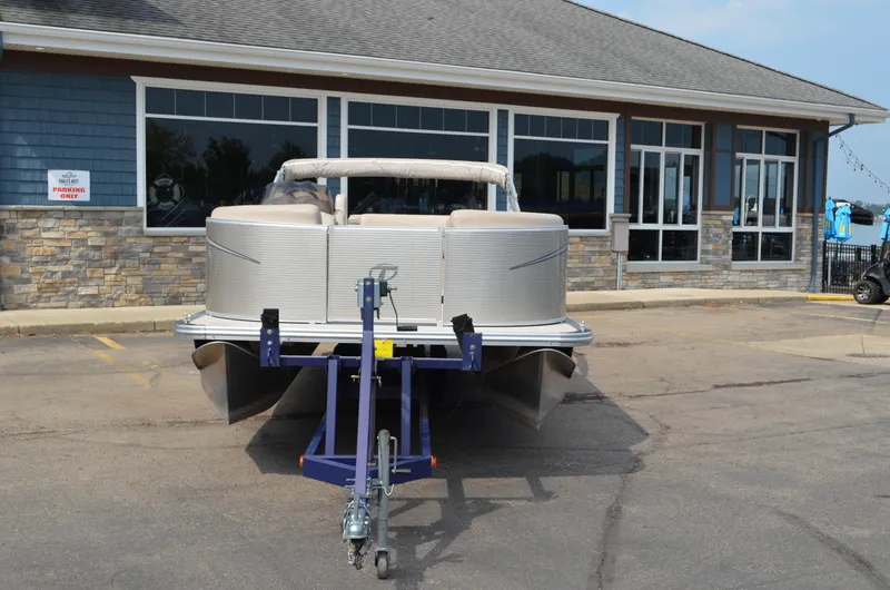 Slide: The Image of 2018 Tahoe LTZ 2285 CR pontoon boat on trailer in front of building. - 3