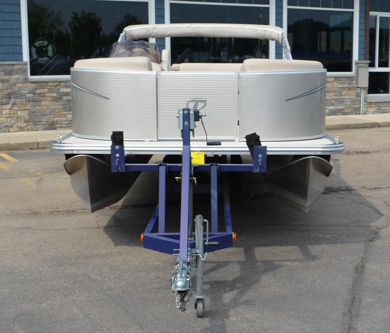 Slide: The Image of 2018 Tahoe LTZ 2285 CR pontoon boat on trailer, parked in front of a building. - 5