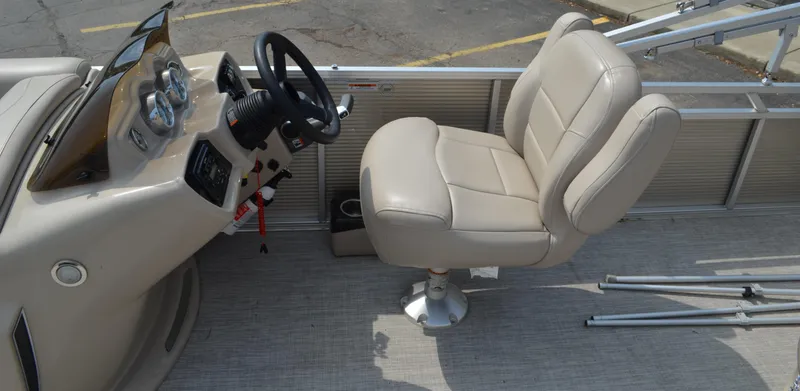 Slide: The Image of 2018 Tahoe LTZ 2285 CR boat interior with beige captain's chair and steering console. - 6