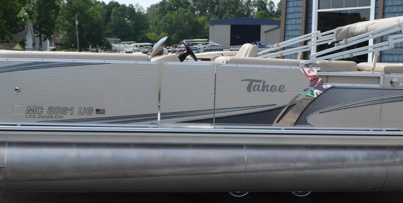 Slide: The Image of 2018 Tahoe LTZ 2285 CR boat interior with beige seating and dashboard. - 7