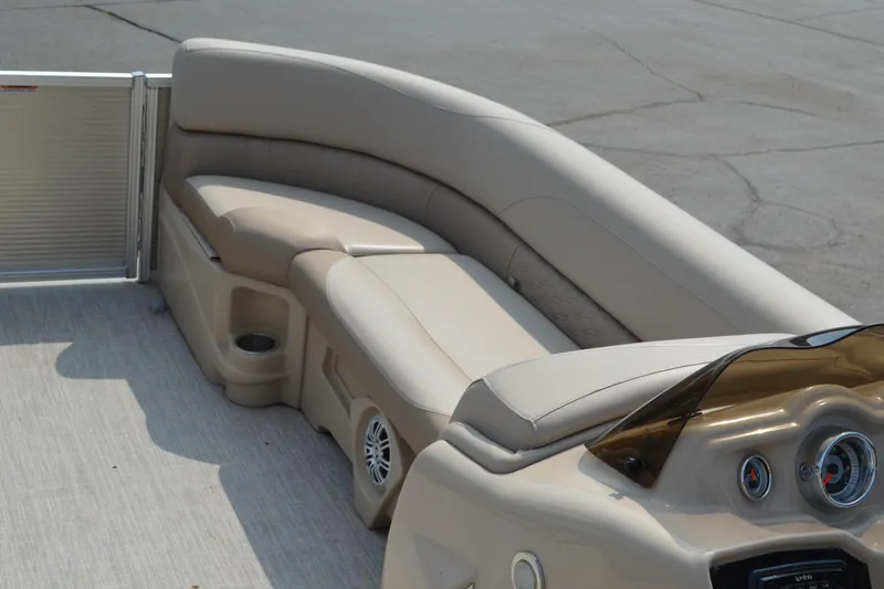 Slide: The Image of 2018 Tahoe LTZ 2285 CR pontoon boat interior with beige seating and steering console. - 8