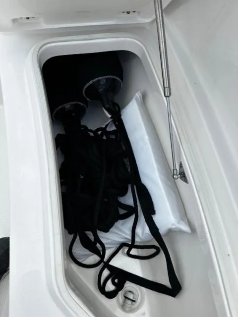 Slide: The Image of Storage compartment in 2022 Robalo R230 Center Console boat with ropes and fenders. - 11