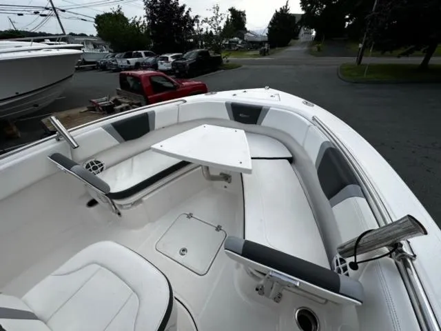 Slide: The Image of 2022 Robalo R230 Center Console boat interior with seating and table. - 12