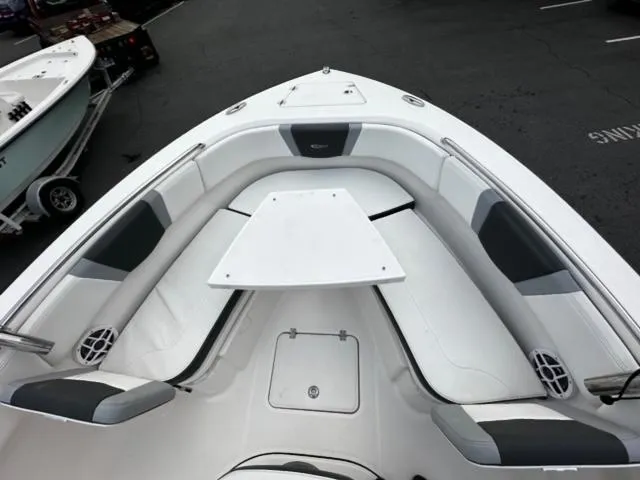 Slide: The Image of 2022 Robalo R230 Center Console boat interior with seating and table. - 13