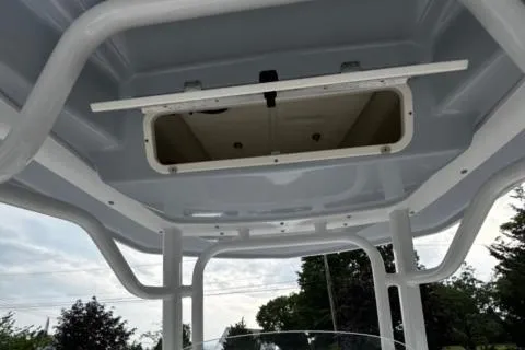 Slide: The Image of 2022 Robalo R230 Center Console T-top interior view with open hatch. - 20