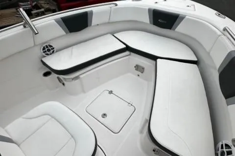 Slide: The Image of 2022 Robalo R230 Center Console boat interior with white cushioned seating. - 23