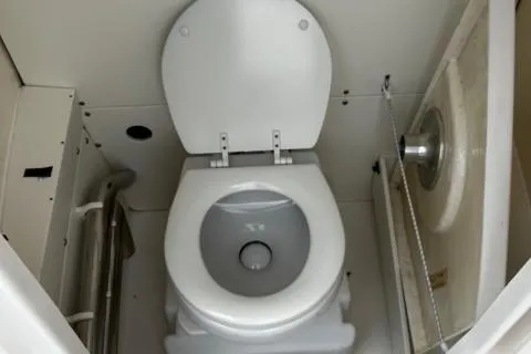 Slide: The Image of 2022 Robalo R230 Center Console boat interior toilet view. - 26