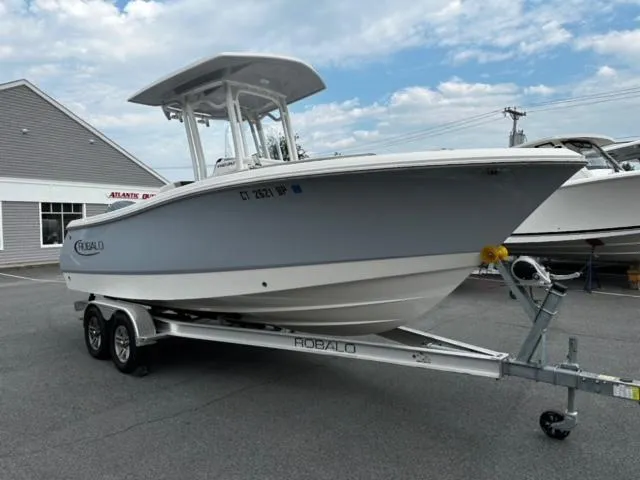 Slide: The Image of 2022 Robalo R230 Center Console boat on trailer, parked outdoors. - 3