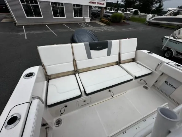 Slide: The Image of 2022 Robalo R230 Center Console boat with white seating in a marina setting. - 6