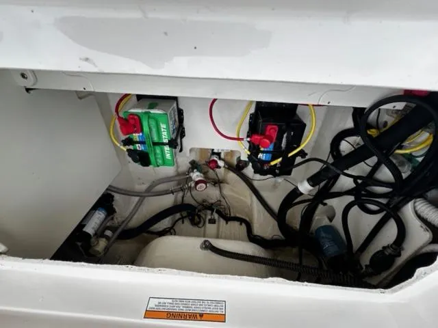 Slide: The Image of 2022 Robalo R230 Center Console boat wiring and battery compartment. - 7