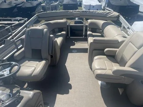 Slide: The Image of 2022 Sun Tracker Party Barge 22 XP3 interior with beige seating and steering wheel. - 4