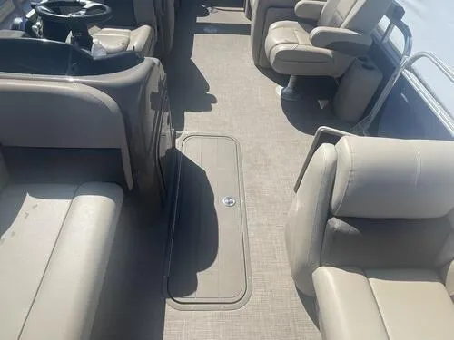 Slide: The Image of 2022 Sun Tracker Party Barge 22 XP3 interior with beige seating and steering wheel. - 8