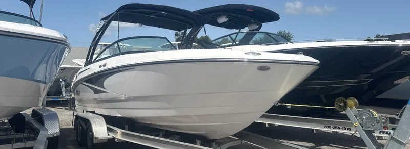 The Image of 2025 Monterey M-225 boat on trailer, sleek design, sunny day. - 0