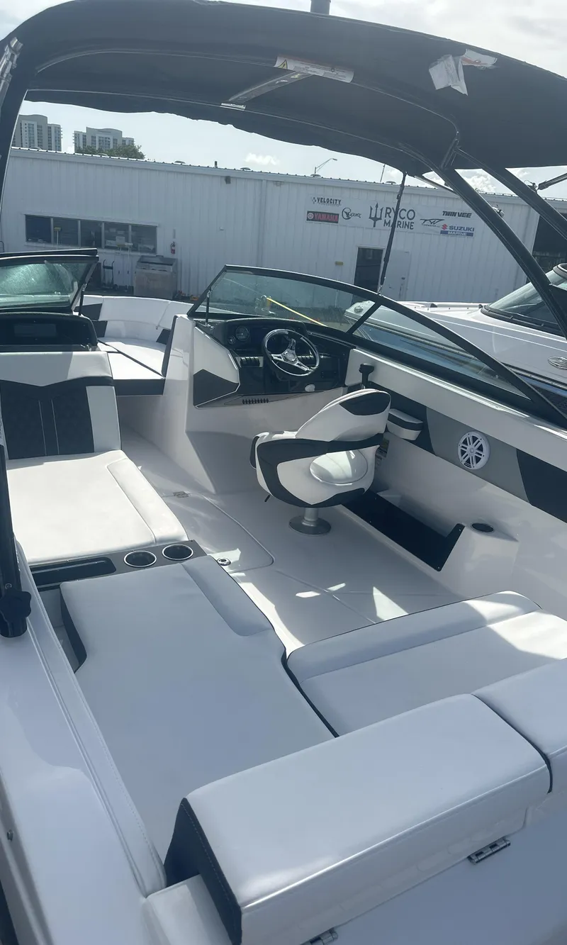 Slide: The Image of 2025 Monterey M-225 boat interior with seating and windshield, displayed outdoors. - 10