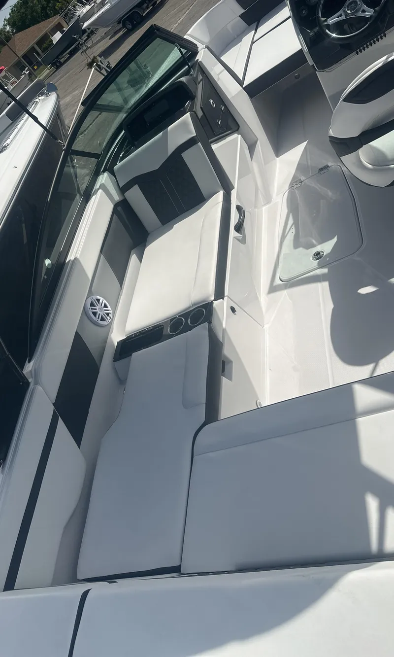 Slide: The Image of 2025 Monterey M-225 boat interior with steering wheel and captain's chair. - 14