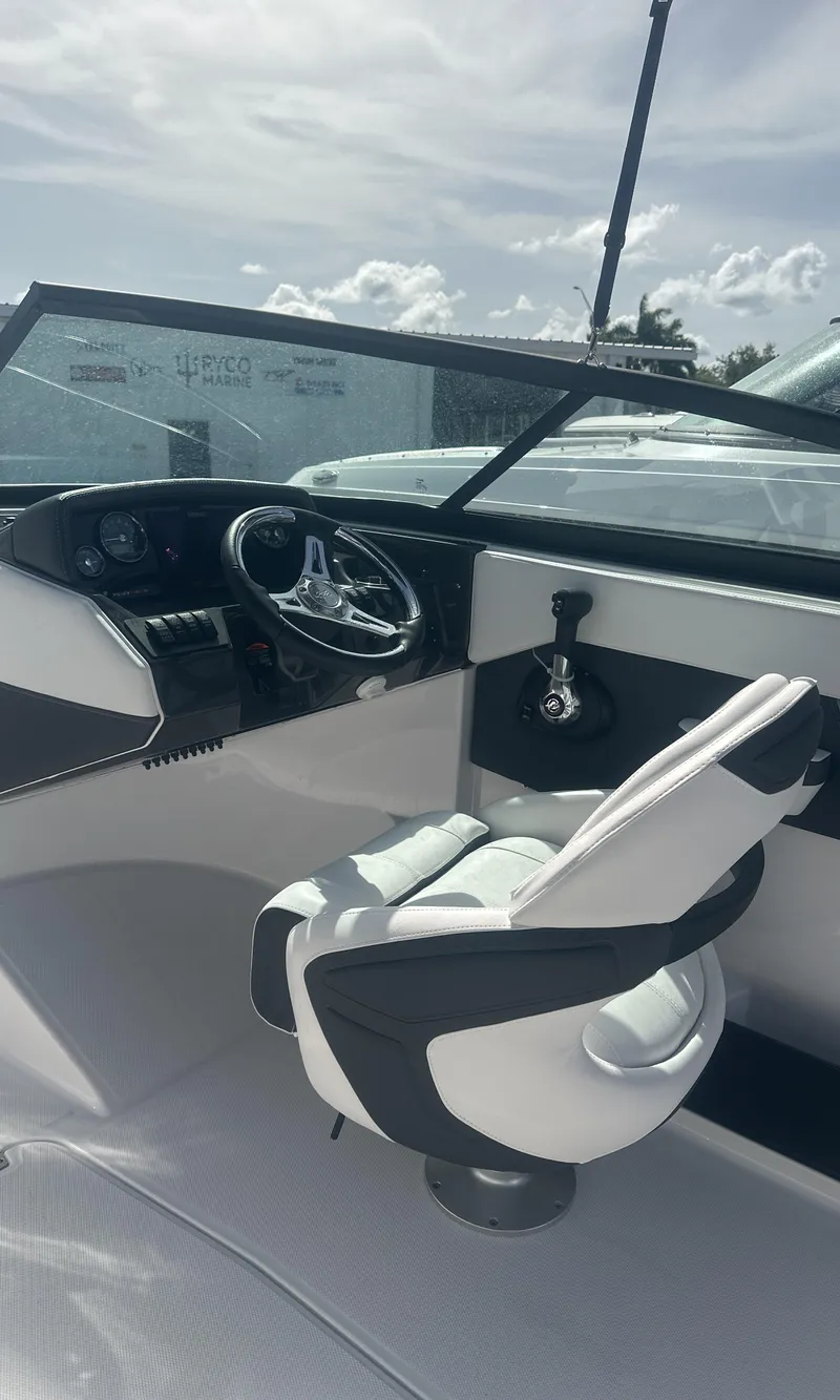 Slide: The Image of 2025 Monterey M-225 boat cockpit with steering wheel and dashboard controls. - 15