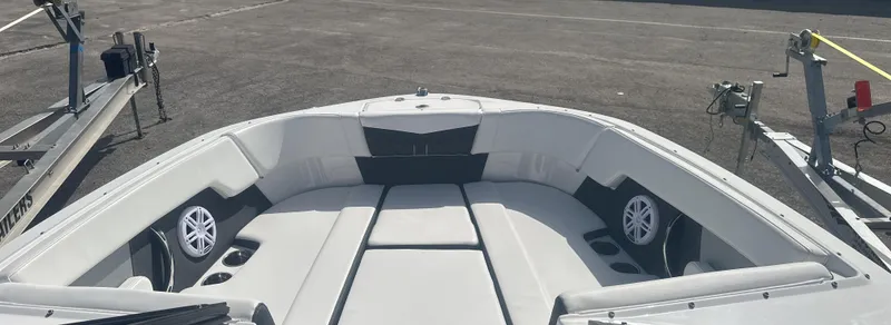 Slide: The Image of 2025 Monterey M-225 boat interior with white seating and cup holders. - 21