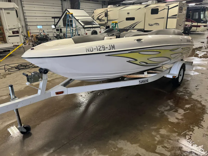 Slide: The Image of 1998 Yamaha Exciter boat on trailer in indoor storage facility. - 1