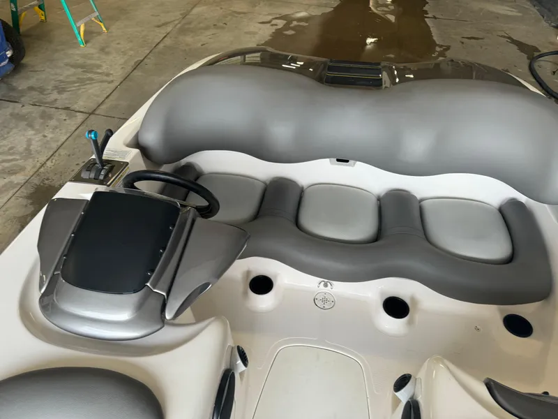 Slide: The Image of 1998 Yamaha Boats Exciter interior with gray seating and steering wheel in a garage setting. - 10