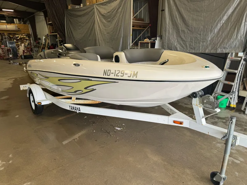 Slide: The Image of 1998 Yamaha Exciter boat on trailer in a garage setting. - 2