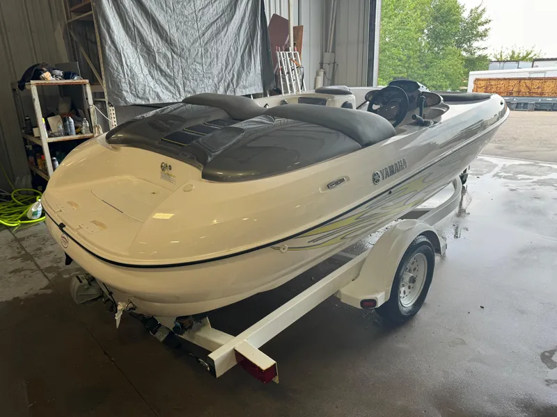 Slide: The Image of 1998 Yamaha Exciter boat on trailer in garage setting. - 3