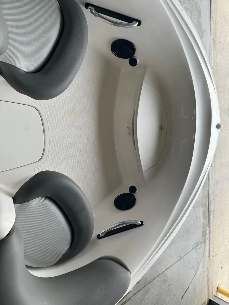 Slide: The Image of 1998 Yamaha Exciter boat interior with gray seating and built-in speakers. - 6