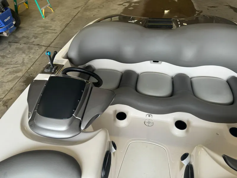 Slide: The Image of 1998 Yamaha Boats Exciter interior with gray seating and steering wheel in a garage setting. - 9