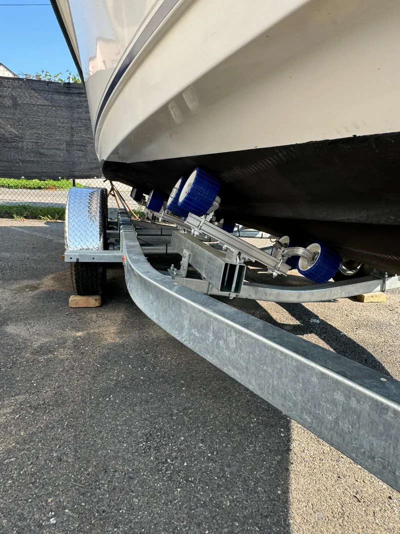 Slide: The Image of 2005 Sea Hunt Triton 232 boat on trailer, close-up view of hull and rollers. - 13