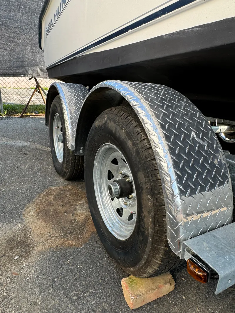 Slide: The Image of Trailer of 2005 Sea Hunt Triton 232 boat with dual wheels and metal fenders. - 14