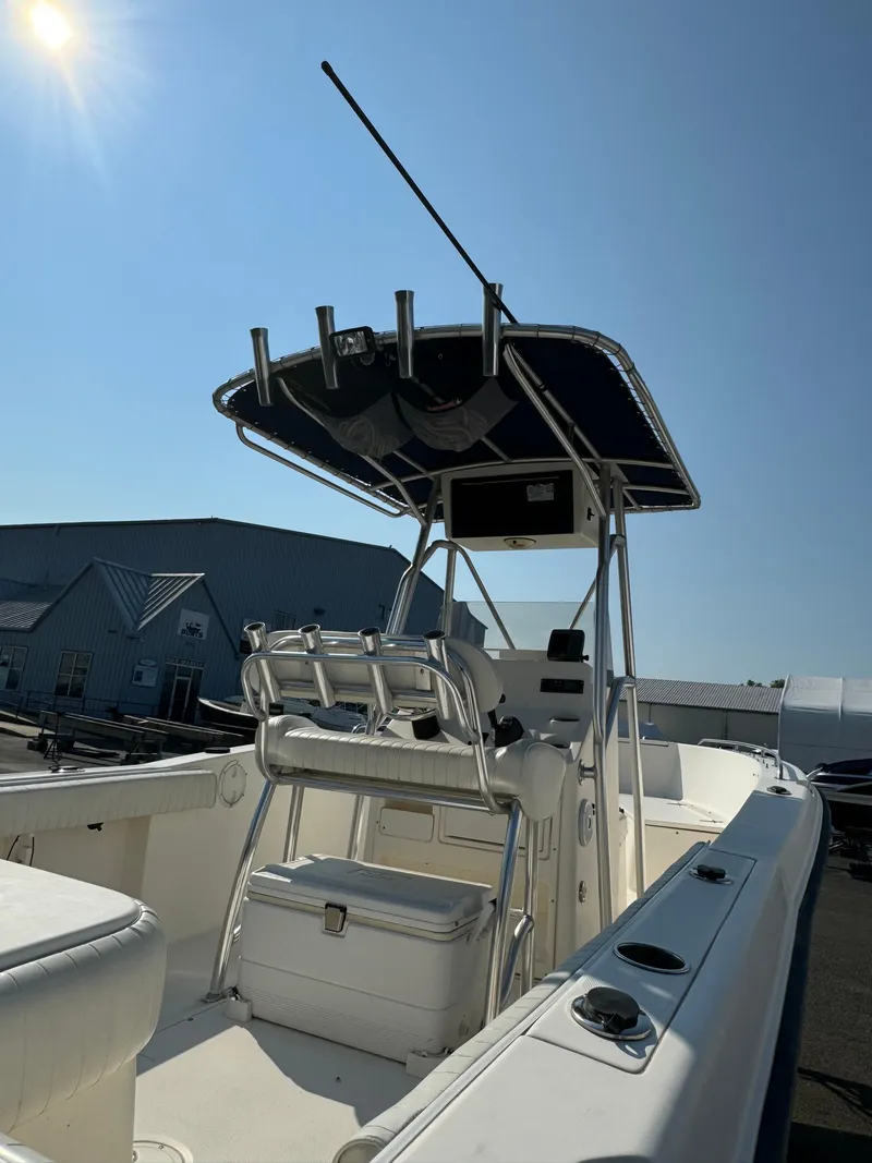 Slide: The Image of 2005 Sea Hunt Triton 232 boat with T-top under clear blue sky. - 15
